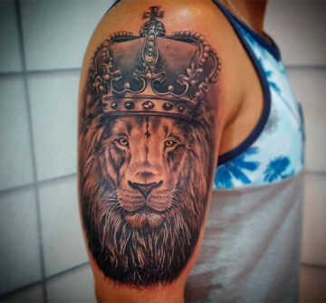 Тату лев с короной на плече у мужчины