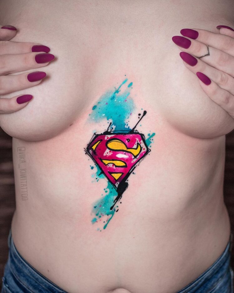 Знак супермена, тату на груди у девушки